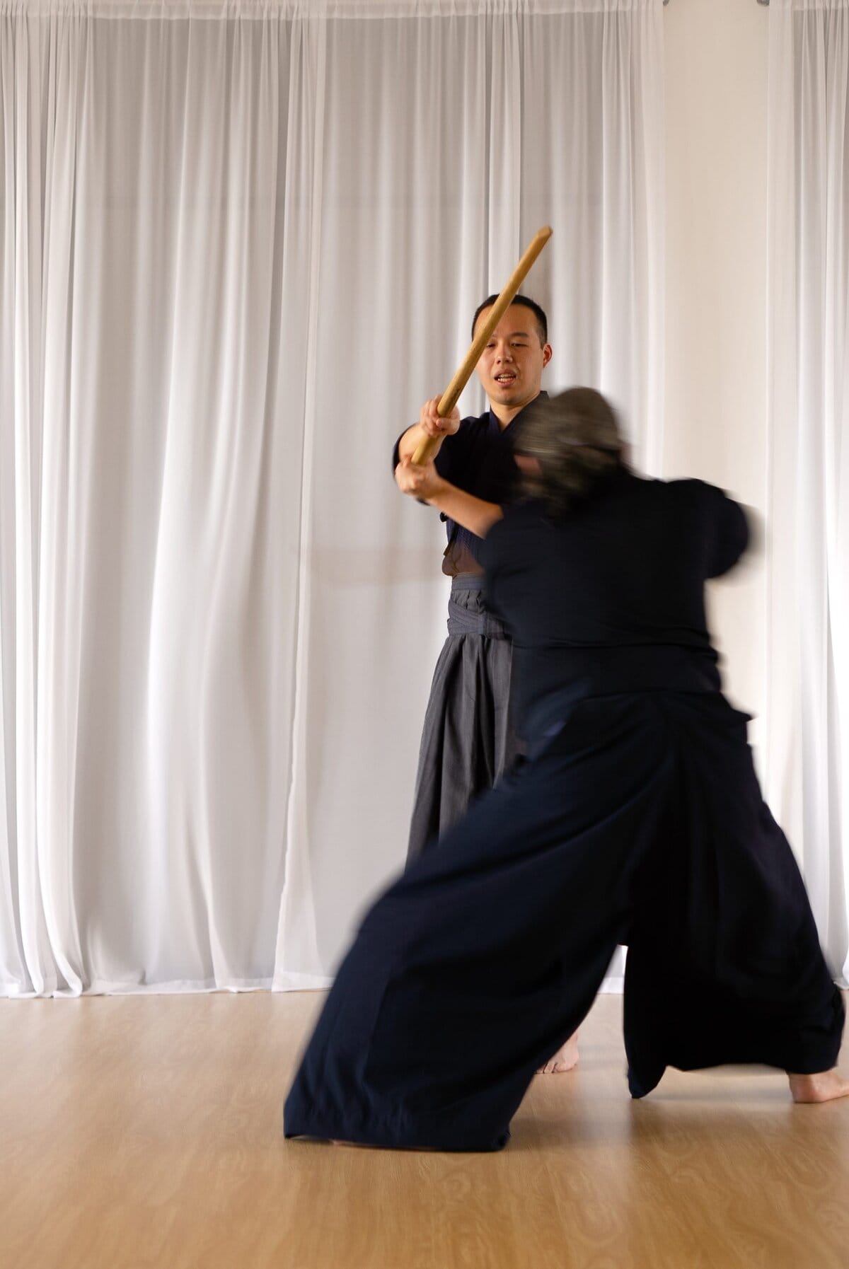 Keiko, intense training while reflecting on the ideals of its rich past. A master charges his apprentice in a sparring session in a dojo for Tenshin Shōden Katori Shintō-ryū in Quezon City, Philippines.