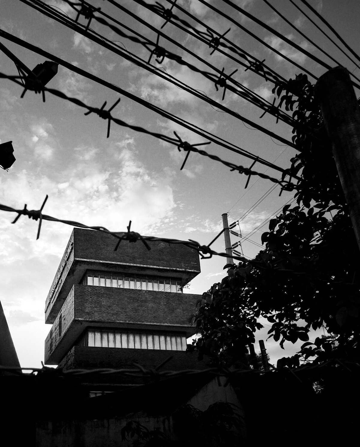 The National Press Club in Manila, the compound as seen from behind a barbed wire fence. The building in the photo is actually the National Press Club Medical Clinic.